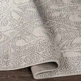 Close-up of the Fernwood Area Rug showing its gray dotted pattern and machine-woven texture. Fold