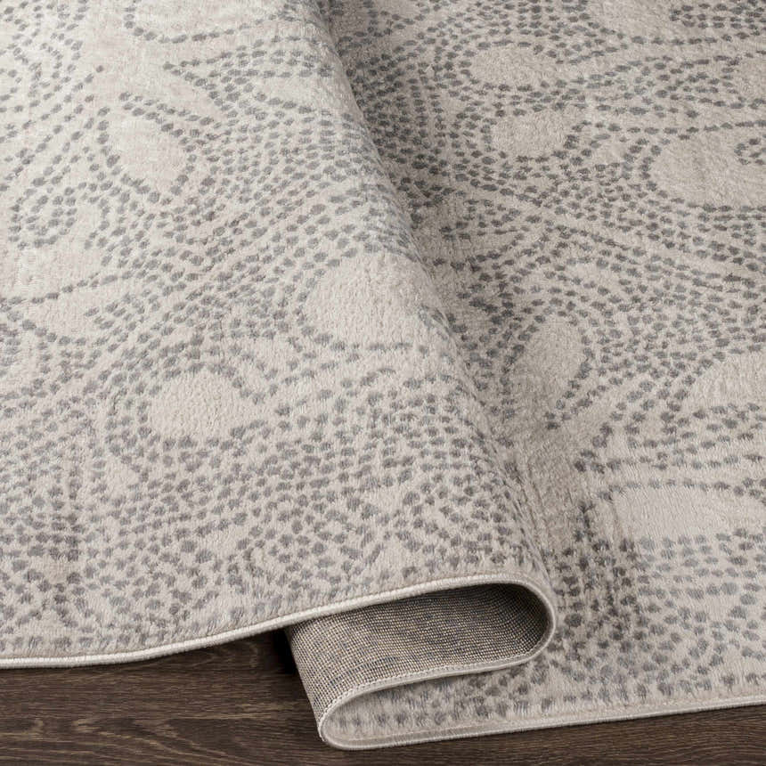 Close-up of the Fernwood Area Rug showing its gray dotted pattern and machine-woven texture. Fold