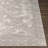 Close-up of the Fernwood Area Rug showing its gray dotted pattern and soft texture on dark wood floor. Front
