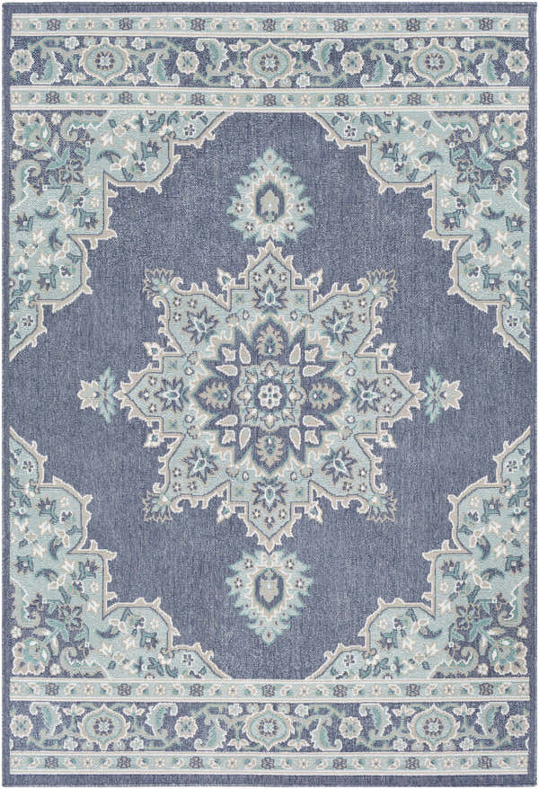 Close-up of the Ferron Area Rug. Navy olefin rug with pale blue, taupe, teal, and white traditional floral pattern. Design-Rectangle-537