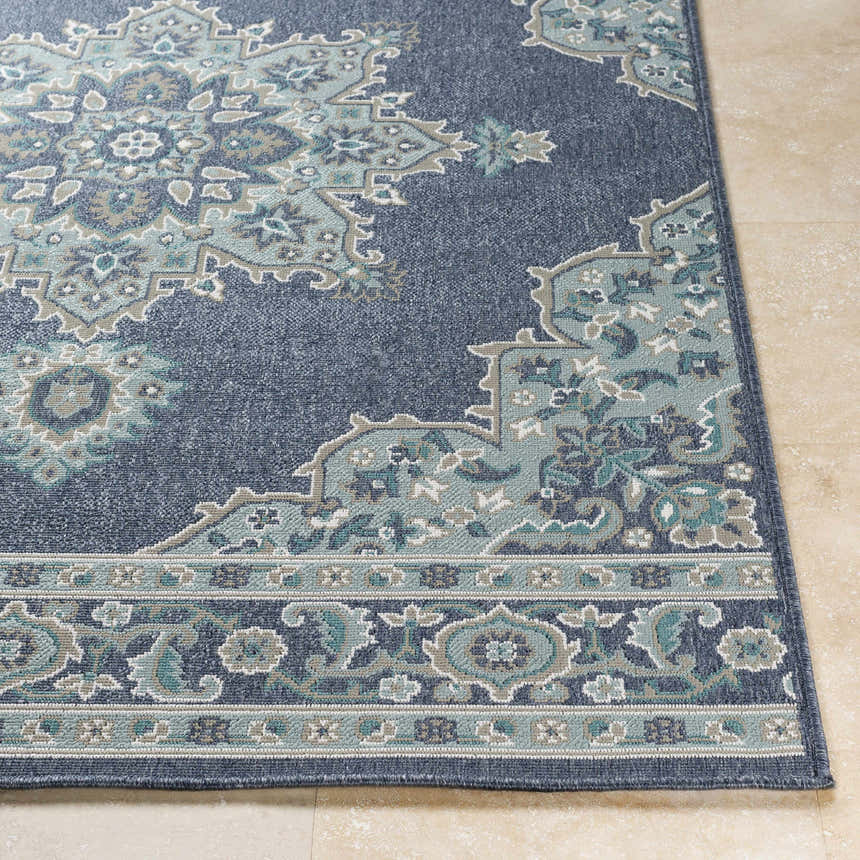 Close up of the Ferron Area Rug showing a navy, teal, and taupe traditional pattern. Front