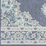 Close up of the Ferron Area Rug showing a navy, teal, and taupe floral and geometric pattern. Swatch
