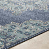 Close up of the Ferron Area Rug showing navy, pale blue, teal, taupe, and white oriental pattern. Texture
