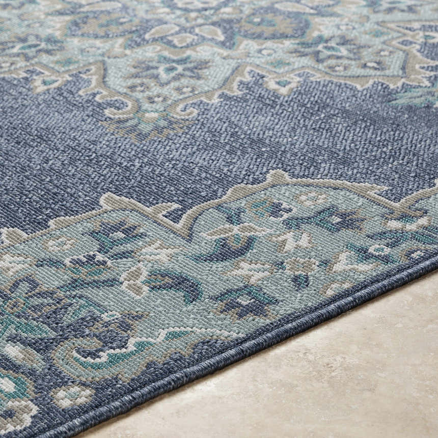 Close up of the Ferron Area Rug showing navy, pale blue, teal, taupe, and white oriental pattern. Texture