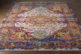 Close-up of the hand-knotted Flagtown Area Rug. Bohemian style with blue, burgundy, coral, and gold colors. Front