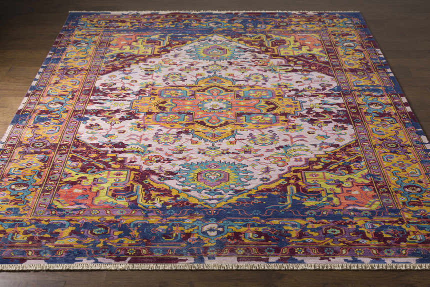 Close-up of the hand-knotted Flagtown Area Rug. Bohemian style with blue, burgundy, coral, and gold colors. Front