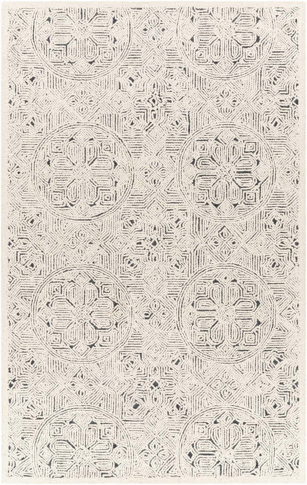 Close-up of the Flatlands Area Rug. Hand-tufted wool rug in cream and charcoal with geometric and floral medallion pattern. Design-Rectangle-576