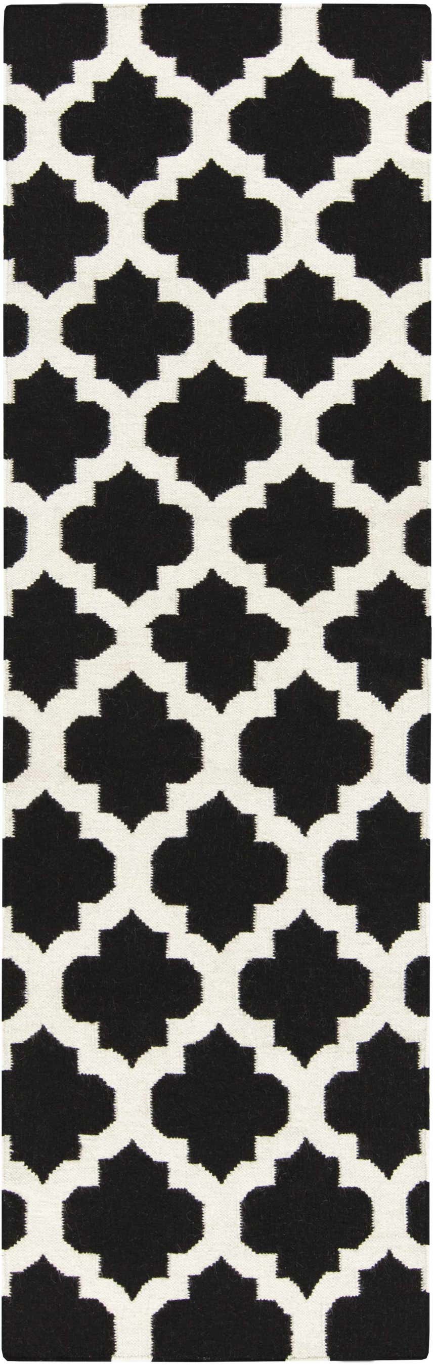 Close-up of the Fleetville Area Rug. Black geometric quatrefoil pattern on an ivory, hand-woven wool rug. Design-Runner-268