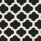 Close-up of the Fleetville Area Rug's black and ivory geometric pattern. Hand-woven wool texture. Swatch