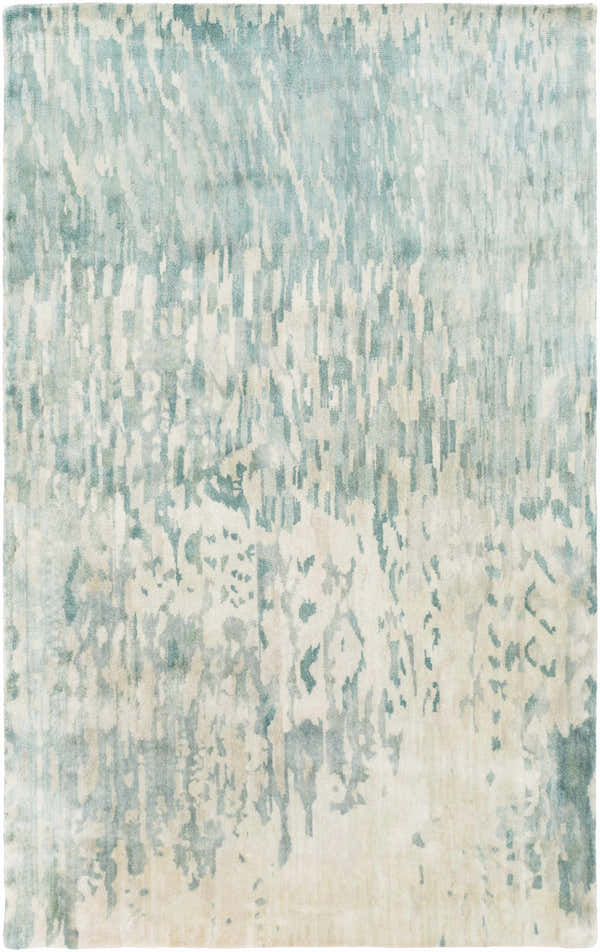 Close-up of the Fonda Area Rug. Hand-knotted wool rug in blue, gray, and taupe with a contemporary abstract pattern. Design-Rectangle-58