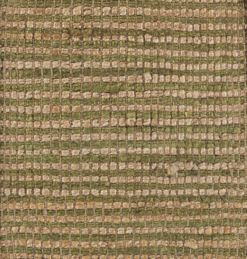 Close up of the Frederic Jute Carpet, featuring a hand woven texture in grass green and tan. Farmhouse style. Texture