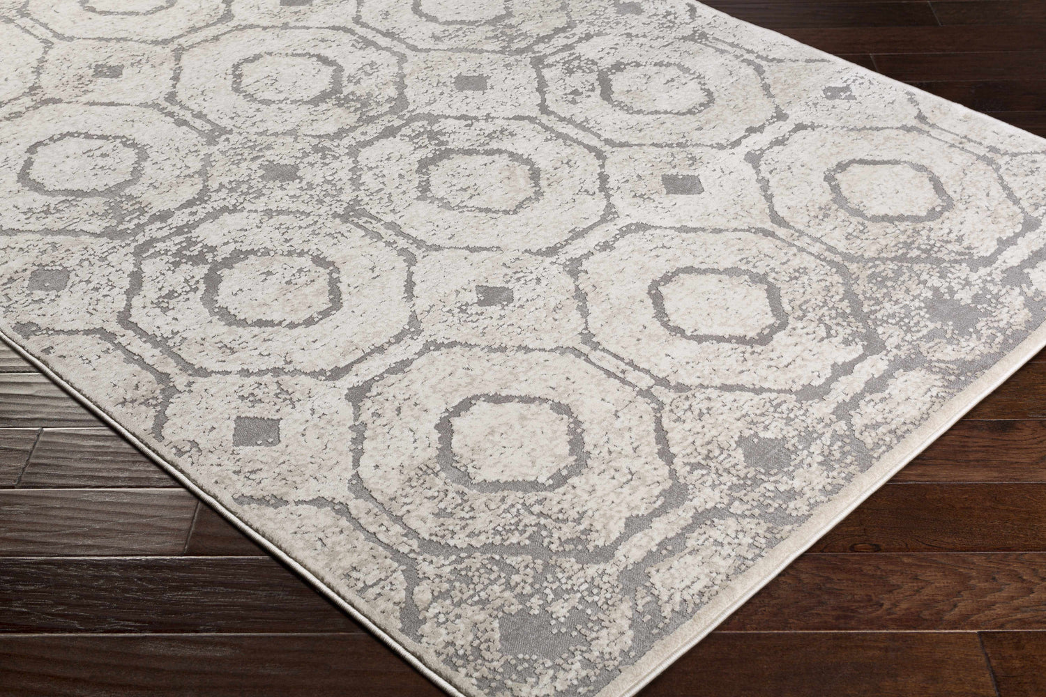 Close-up of the Frenchtown Area Rug, a clearance item with a geometric pattern in neutral beige and gray tones. Corner