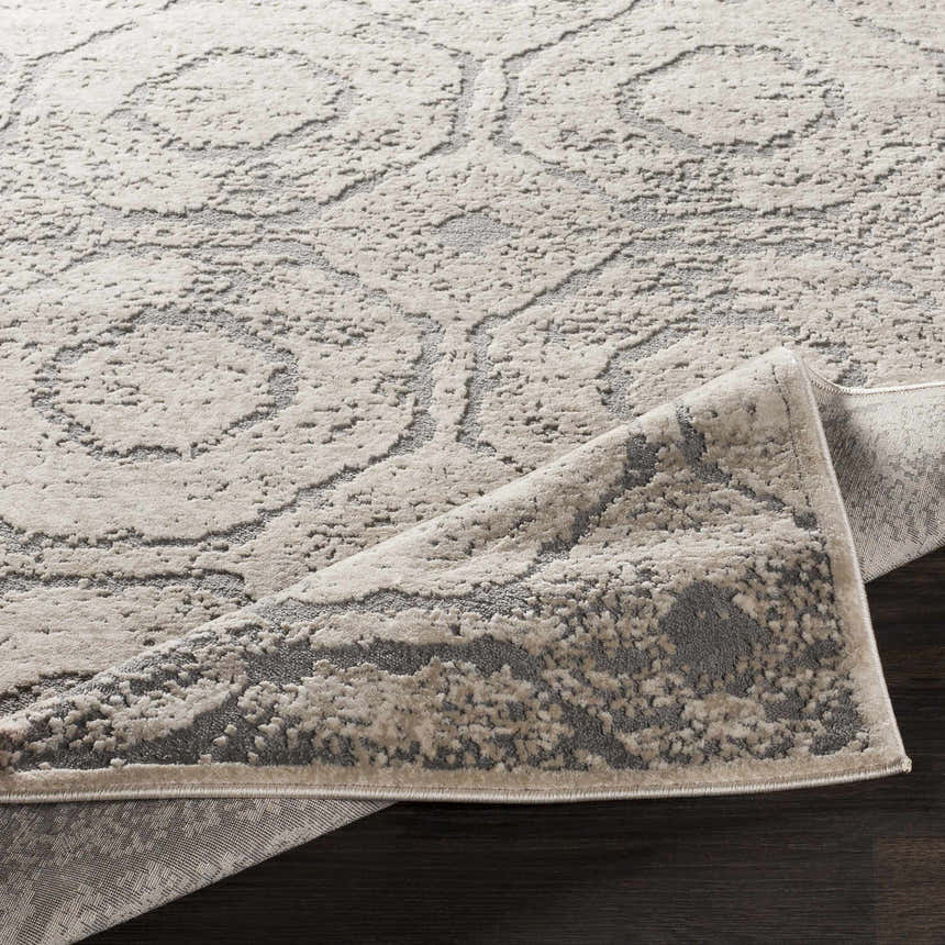 Close-up of the Frenchtown Area Rug, a clearance item with a gray and beige floral pattern and textured design. Fold