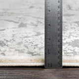 Close-up of Frenchtown Area Rug showing pile height with ruler. Neutral gray and white abstract pattern. Clearance rug. Pile