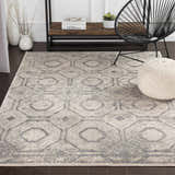 Living room scene with a Frenchtown Area Rug in gray and cream, black chair, and white pouf. Roomscene-Rectangle
