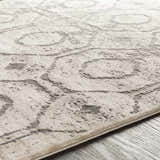 Close-up of the Frenchtown Area Rug, showing its textured, light beige and gray swirling pattern. Texture