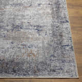 Close-up of Fairplains Washable Area Rug. Features a vintage design with charcoal, gray, dark blue, and brown tones. Front