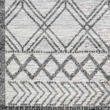 Close-up of the Gada Area Rug, a hand-woven rug with a gray and light gray geometric diamond pattern. Swatch