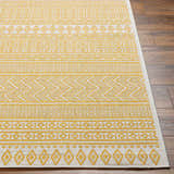 Close-up of the Galal Area Rug showing its beige and dark orange geometric pattern and machine-woven texture. Front
