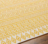 Close-up of the Galal Area Rug, a machine-woven rug with a geometric pattern in beige and yellow. Farmhouse style. Texture
