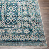 Close-up of Gandy Washable Area Rug; blue, cream, and ink blue geometric pattern; machine woven polyester rug. Front