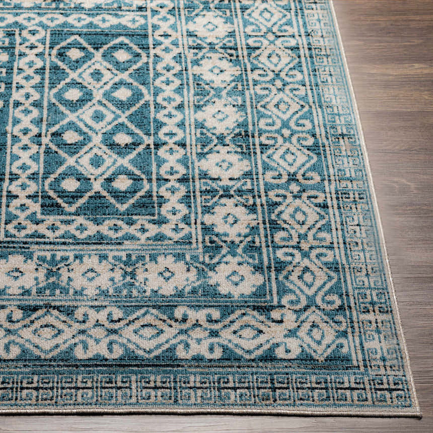Close-up of Gandy Washable Area Rug; blue, cream, and ink blue geometric pattern; machine woven polyester rug. Front