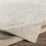 Close-up of the Eaglehawk Luxe Rug showing its cream and charcoal textured design and durable backing. Fold