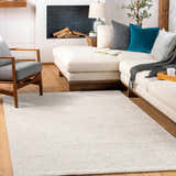 Living room scene with cream sectional sofa and light beige Eaglehawk Luxe Rug on hardwood floors. Roomscene-Rectangle