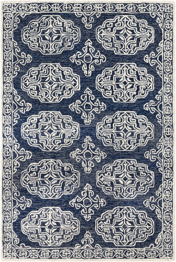 Close-up of the Glenoma Blue Regency Wool Rug, featuring a detailed beige pattern on a navy background and a decorative border. Design-Rectangle-576