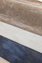 Close-up of Galata Area Rug in brown, cream, and navy. Hand-loomed with a solid design and subtle texture. Styleshot