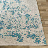 Close-up of the Sweeny Beige/Blue Abstract Area Rug showing the contemporary pattern and hand-woven texture. Front