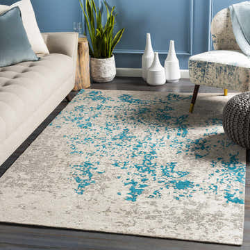 Living room scene with a Sweeny Beige/Blue Abstract Area Rug, sofa, chair, and blue accent wall. Roomscene-Rectangle