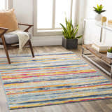 Living room scene with a Gooburrum Area Rug. The rug has burnt orange, fuchsia, gray, mustard, and navy stripes. Roomscene-Rectangle