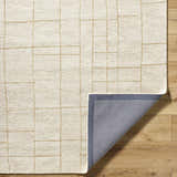 Close-up of the Ailani Area Rug showing the ash and pearl geometric pattern, wool texture, and rug backing. Fold