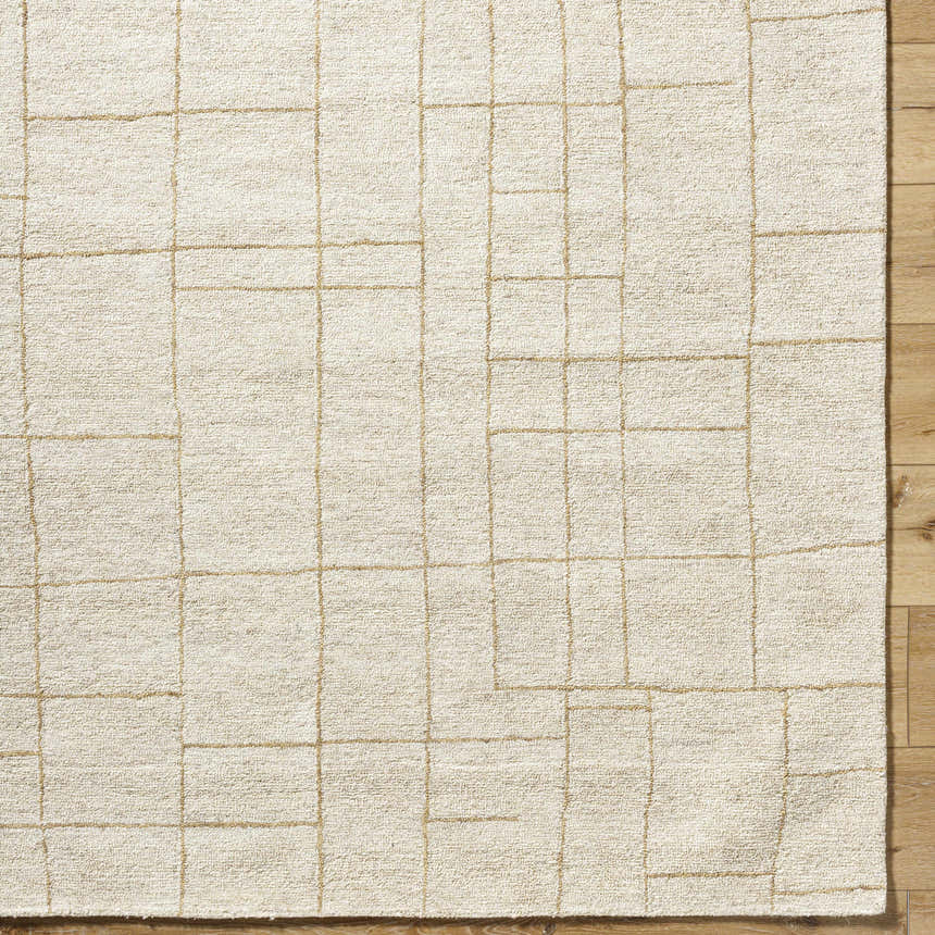 Close up of the hand-tufted Ailani Area Rug. Ash and pearl wool rug with a geometric grid pattern. Farmhouse style. Corner