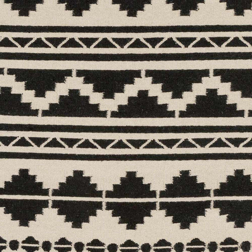 Close-up of the Gratiot Area Rug. Hand woven rug with black geometric patterns on a medium gray background. Swatch