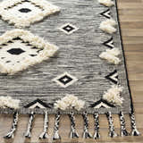 Close-up of the Gardner Cream on Gray Wool Tassel Rug, showcasing the woven texture, geometric pattern, and braided tassels. Front