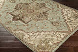Close-up of the Granger Area Rug featuring a traditional oriental design in sage, beige, brown, and burgundy. Corner