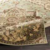 Close-up of the Granger Area Rug, a traditional design in burgundy, beige, sage, and brown tones. Fold