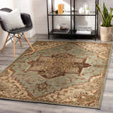 Modern living room scene with a beige and sage Granger Area Rug, black chair, and shelving unit. Roomscene-Rectangle
