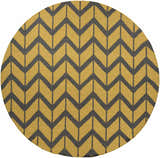 Close-up of a round Groves Area Rug with a charcoal chevron pattern on a mustard yellow wool background. Design-Round-8