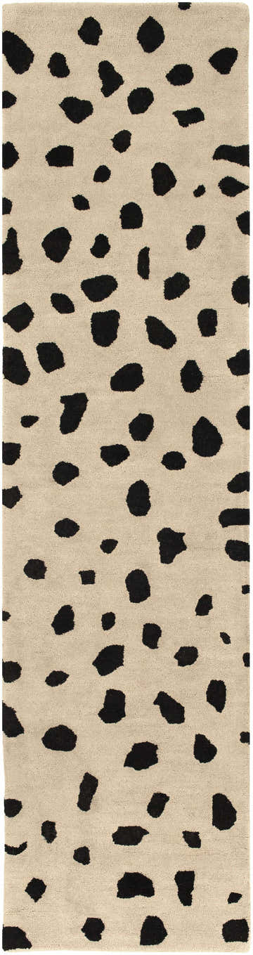 Close-up of the Guiseley Dalmatian Area Rug. Beige wool rug with a black dalmatian spot pattern. Hand-tufted texture. Design-Runner