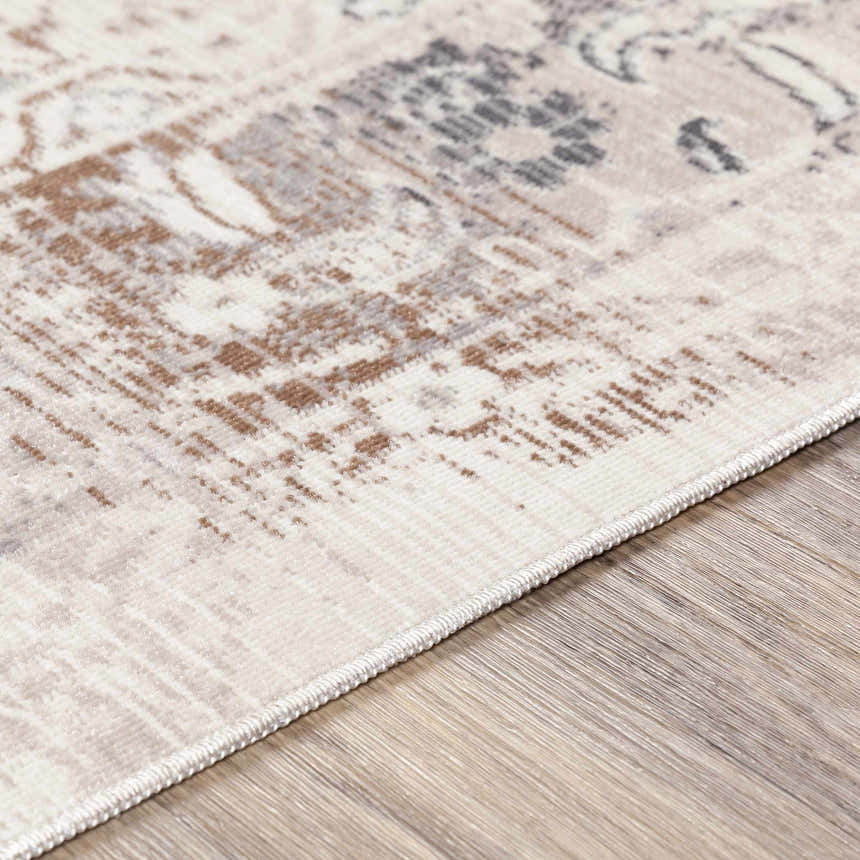 Close-up of Hainesville White Medallion 10' Runner Rug. Farmhouse style rug with neutral tones and traditional medallion pattern. Texture