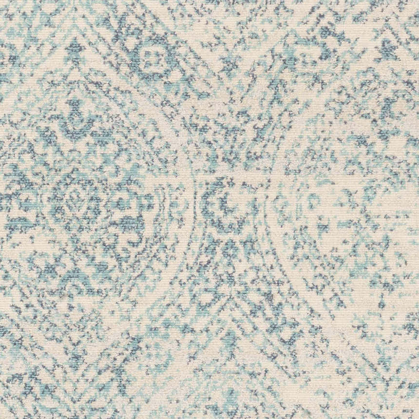 Close-up of the Halbur Area Rug. Beige rug with an aqua and blue distressed, geometric pattern. Swatch