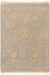 Close-up of the Haleiwa Clearance Rug. Hand-knotted wool rug in camel, taupe, and dark green with a traditional medallion pattern and fringe. Design-Rectangle-23