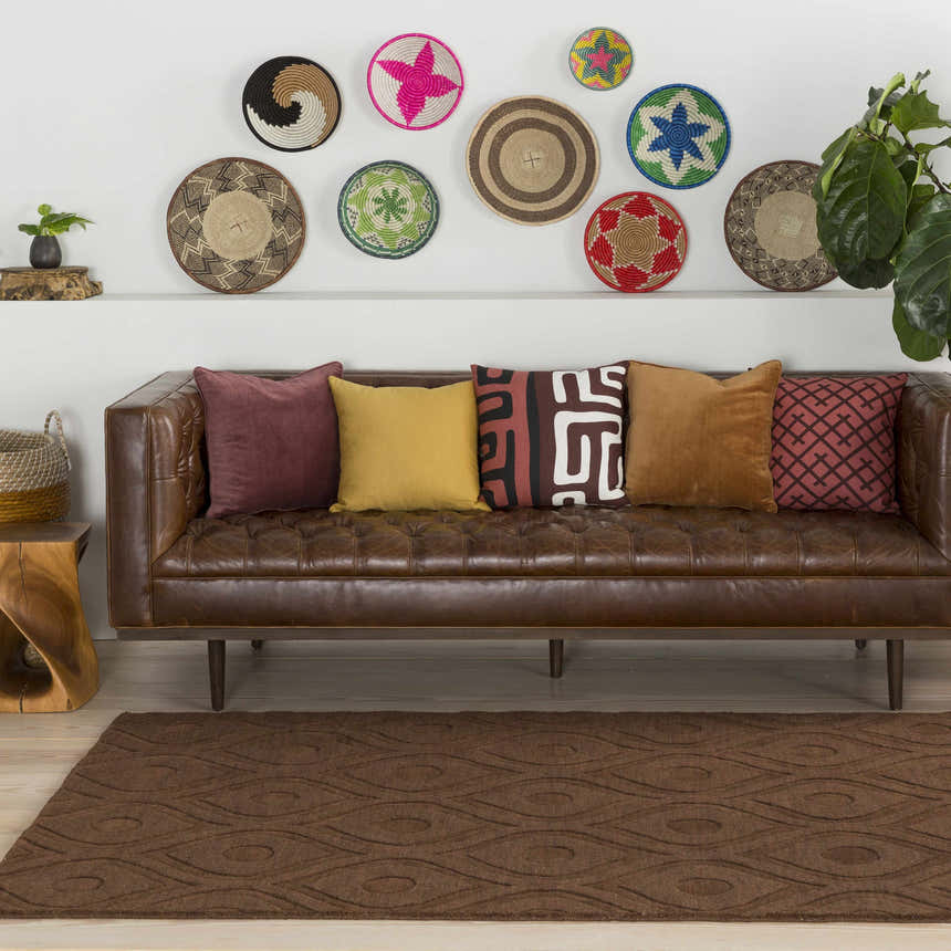 Living room scene with a brown leather sofa and the Hamptonville Area Rug in dark brown. Roomscene-Rectangle