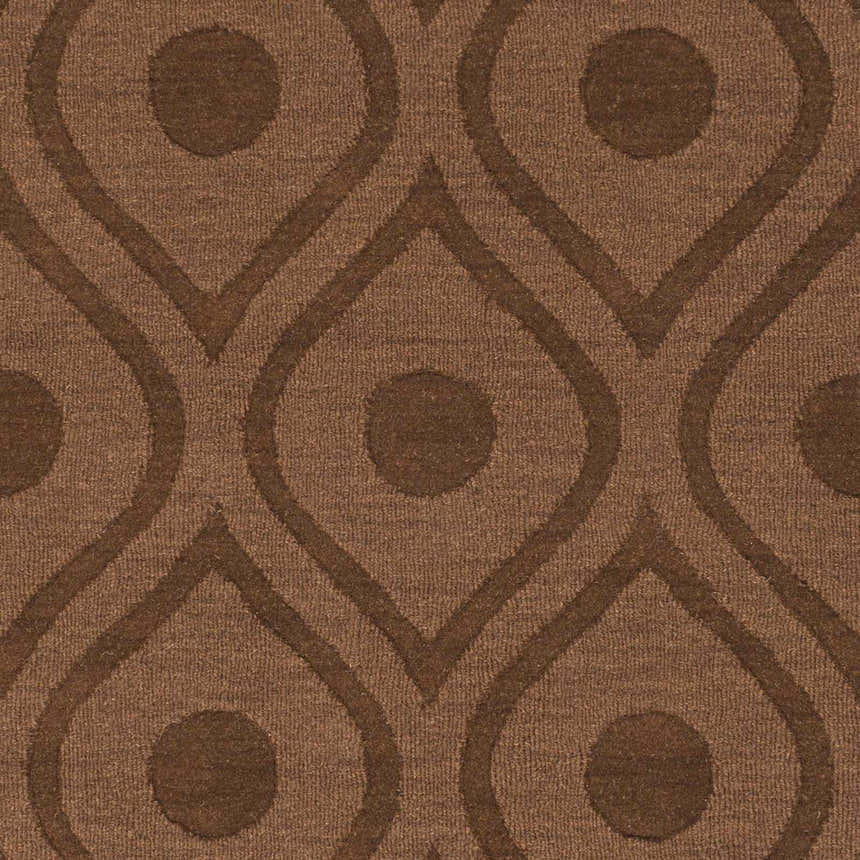Close-up of the Hamptonville Area Rug in dark brown, featuring a geometric teardrop and circle pattern. Wool texture. Swatch