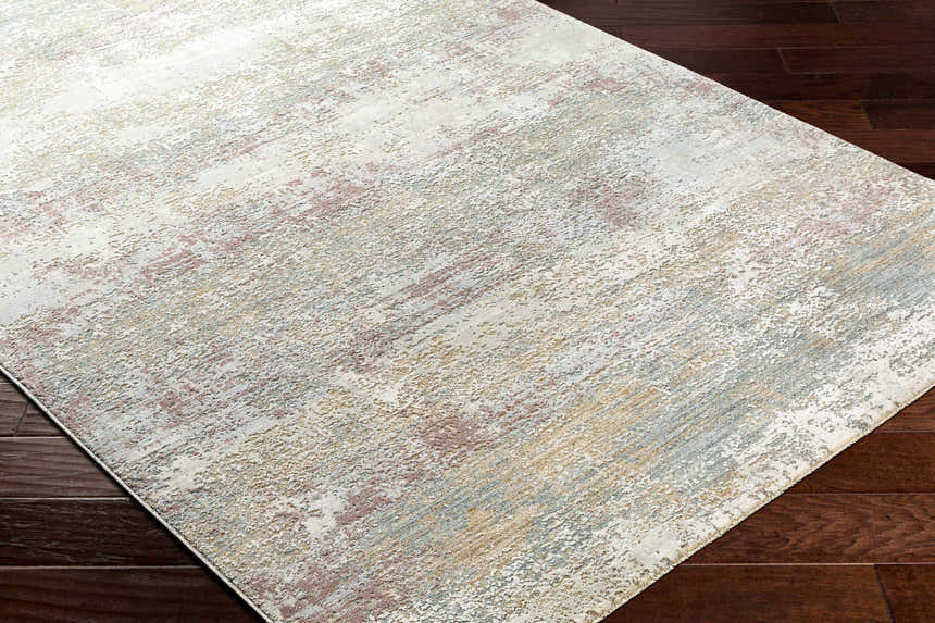Close-up of the Hanne Thick Luxe Rug showing its abstract pattern and colors like gray, brown, and nutmeg. Corner