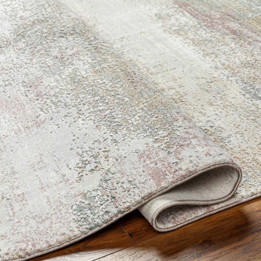 Close-up of the Hanne Thick Luxe Rug showing its gray, brown, and blush pink abstract pattern and soft, textured weave. Fold