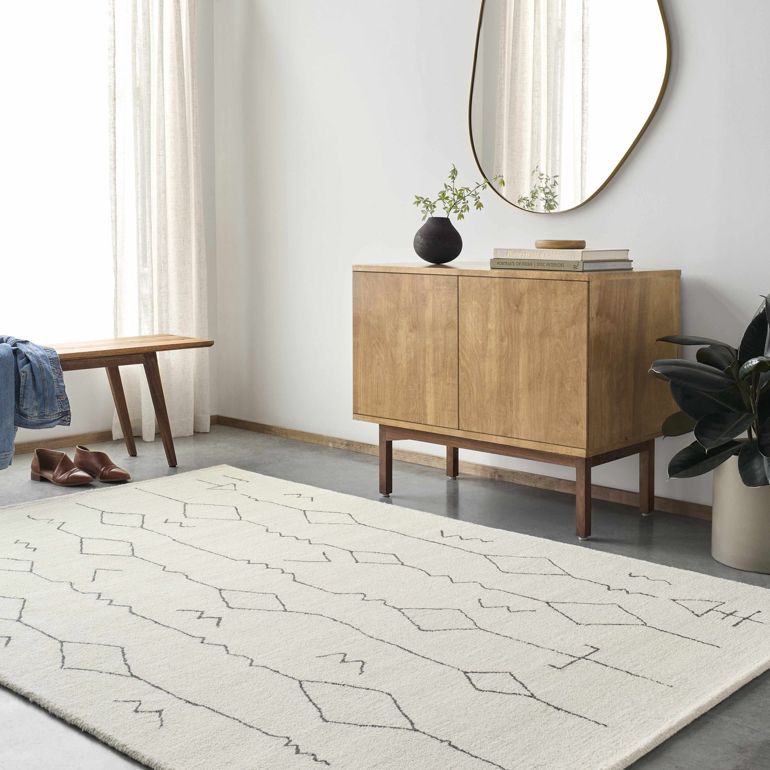 Entryway with beige Hanny Area Rug, wood cabinet, bench, and oval mirror creating a modern farmhouse look. Roomscene-Rectangle